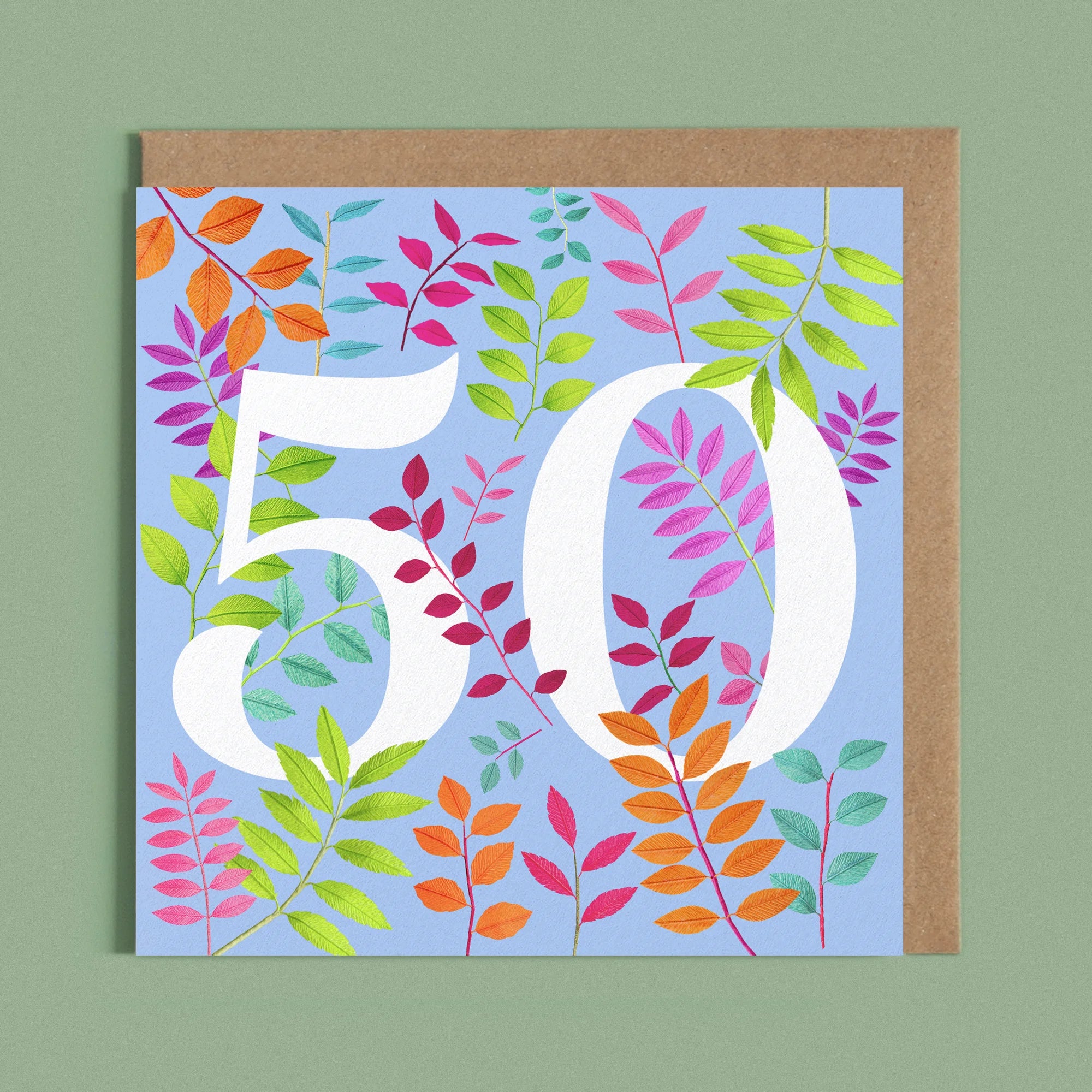 Greeting card with a image of a white number 50 and colourful handcrafted paper foliage on a blue background by paper artist Daphne Fitch.