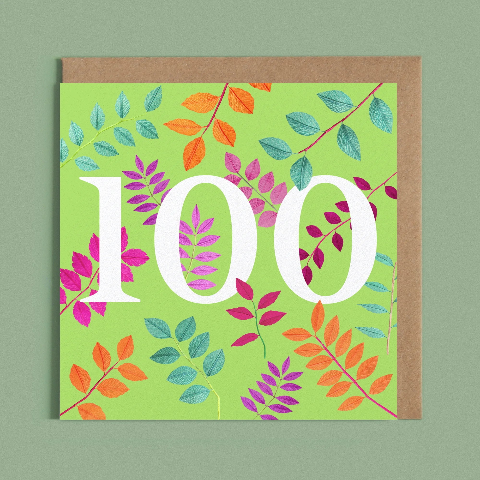 Greeting card with a image of a white number 100 and colourful handcrafted paper foliage on a bright green background by paper artist Daphne Fitch.