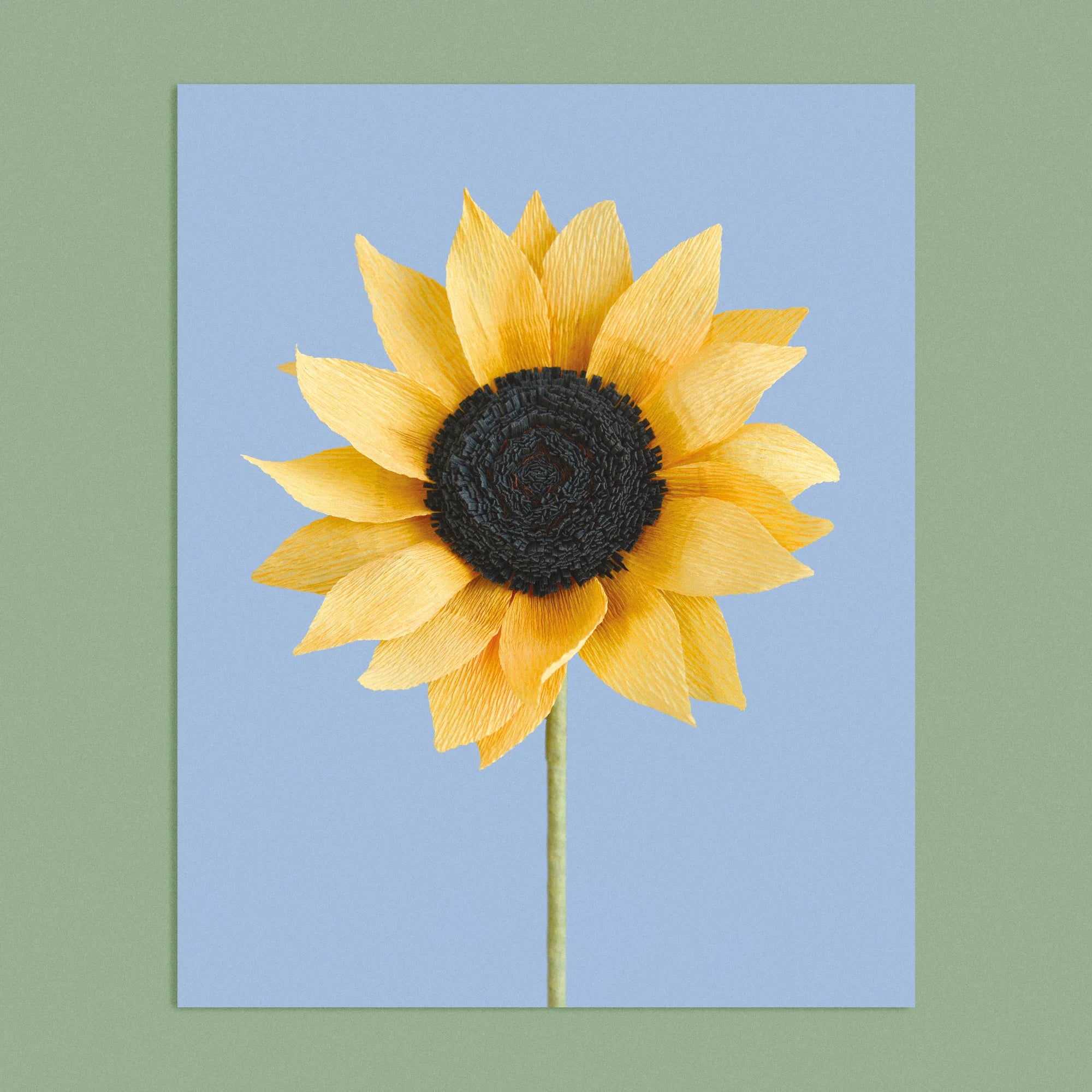 Art print with a image of a handcrafted paper sunflower on a blue background colour by paper artist Daphne Fitch.