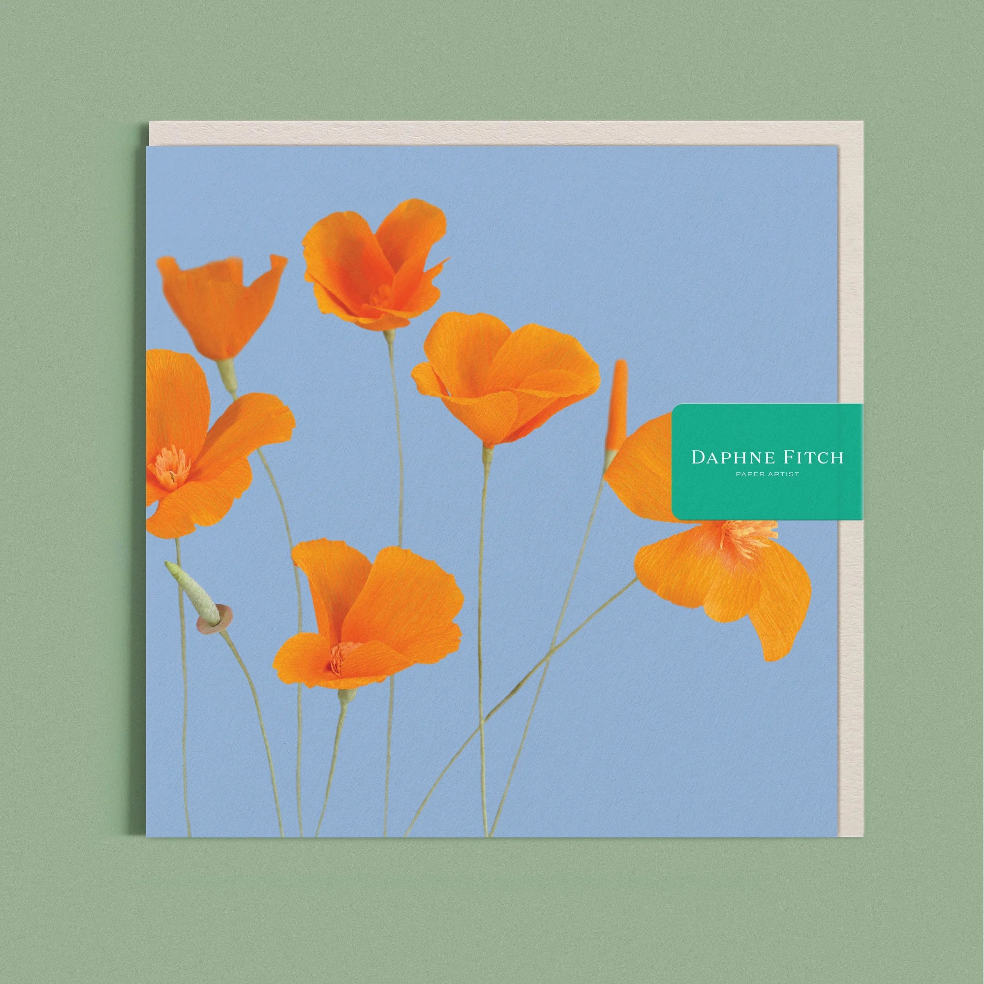 Greeting card with a image of a handcrafted paper orange Californian Poppies on a light blue background by paper artist Daphne Fitch.