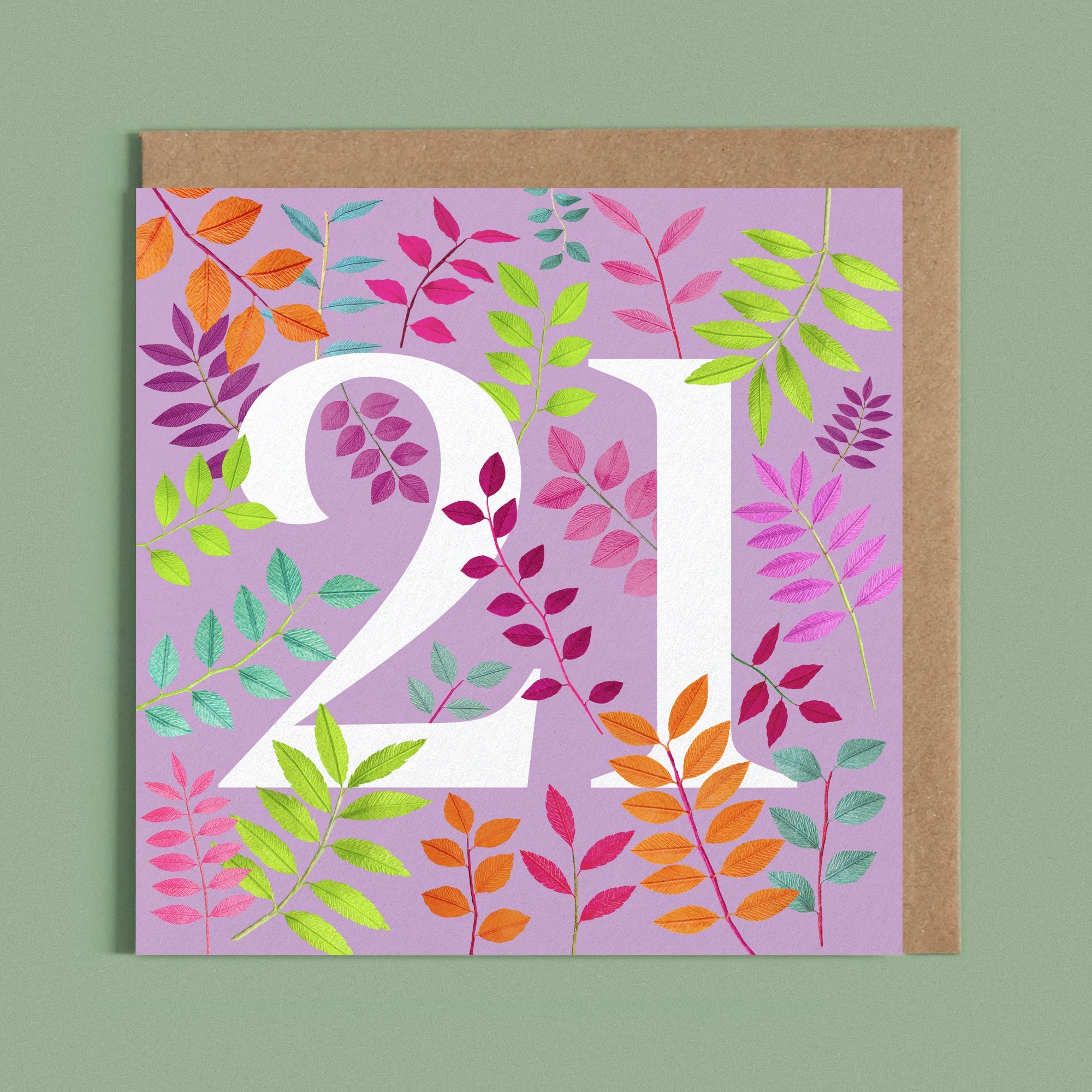 Greeting card with a image of a white number 21 and colourful handcrafted paper foliage on a purple background by paper artist Daphne Fitch.