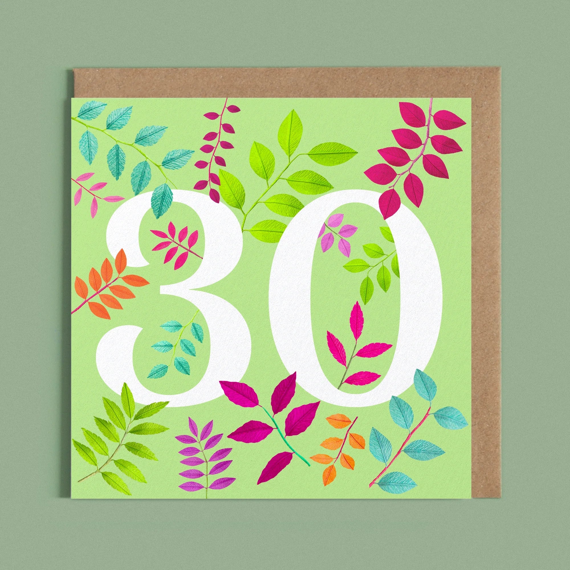 Greeting card with a image of a white number 30 and colourful handcrafted paper foliage on a light green background by paper artist Daphne Fitch.