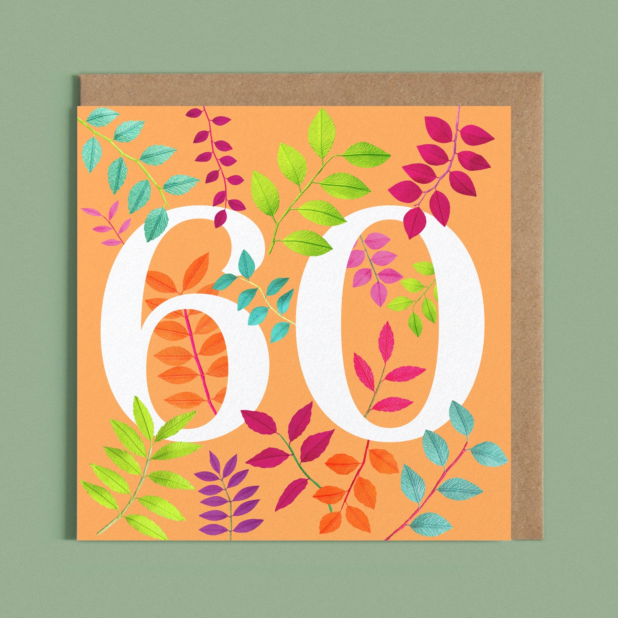 Greeting card with a image of a white number 60 and colourful handcrafted paper foliage on a orange background by paper artist Daphne Fitch.