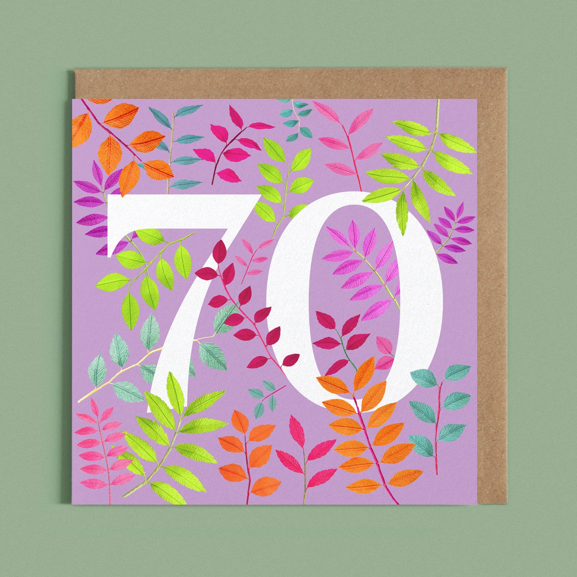 Greeting card with a image of a white number 70 and colourful handcrafted paper foliage on a purple background by paper artist Daphne Fitch.