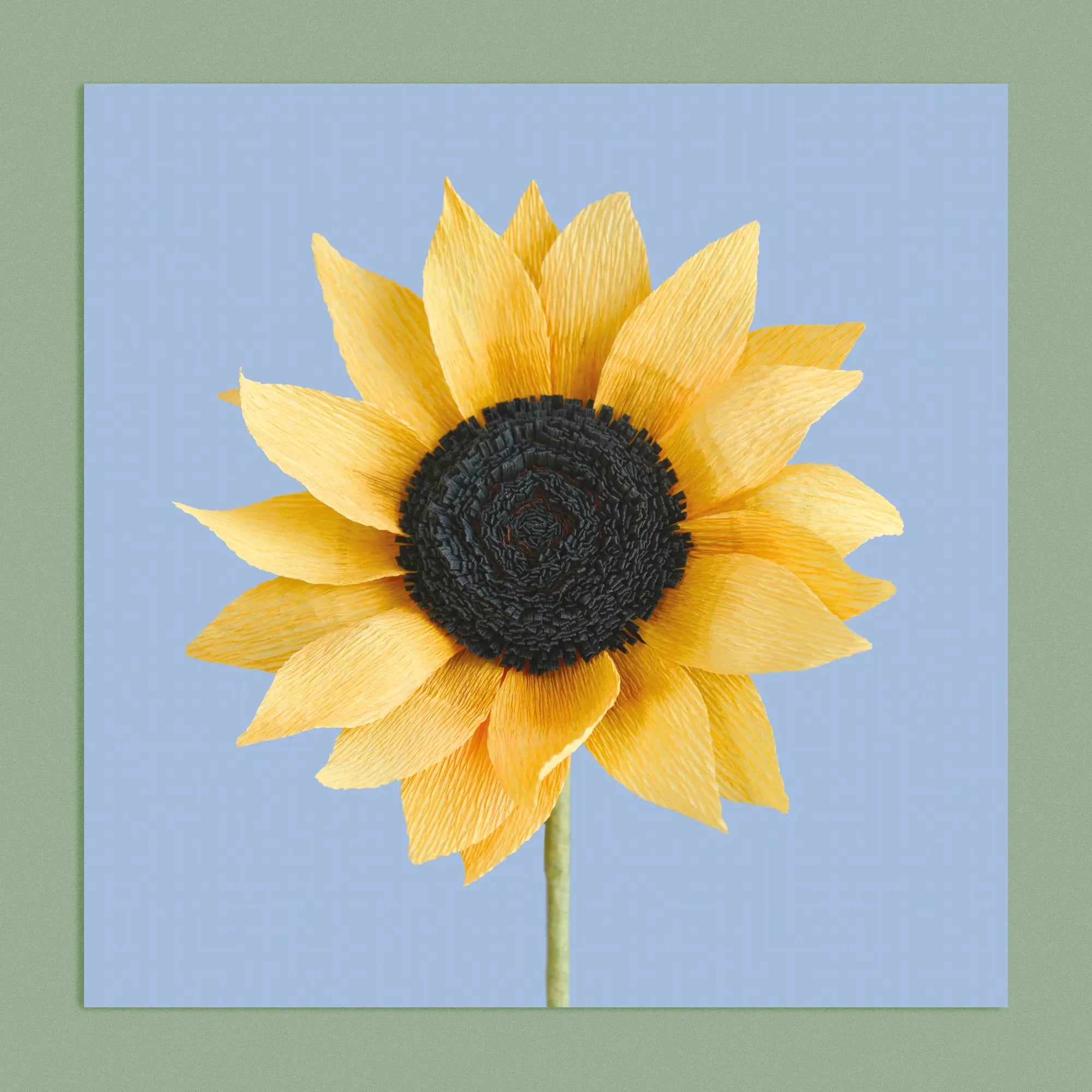 Art print with a image of a handcrafted paper sunflower on a blue background colour by paper artist Daphne Fitch.