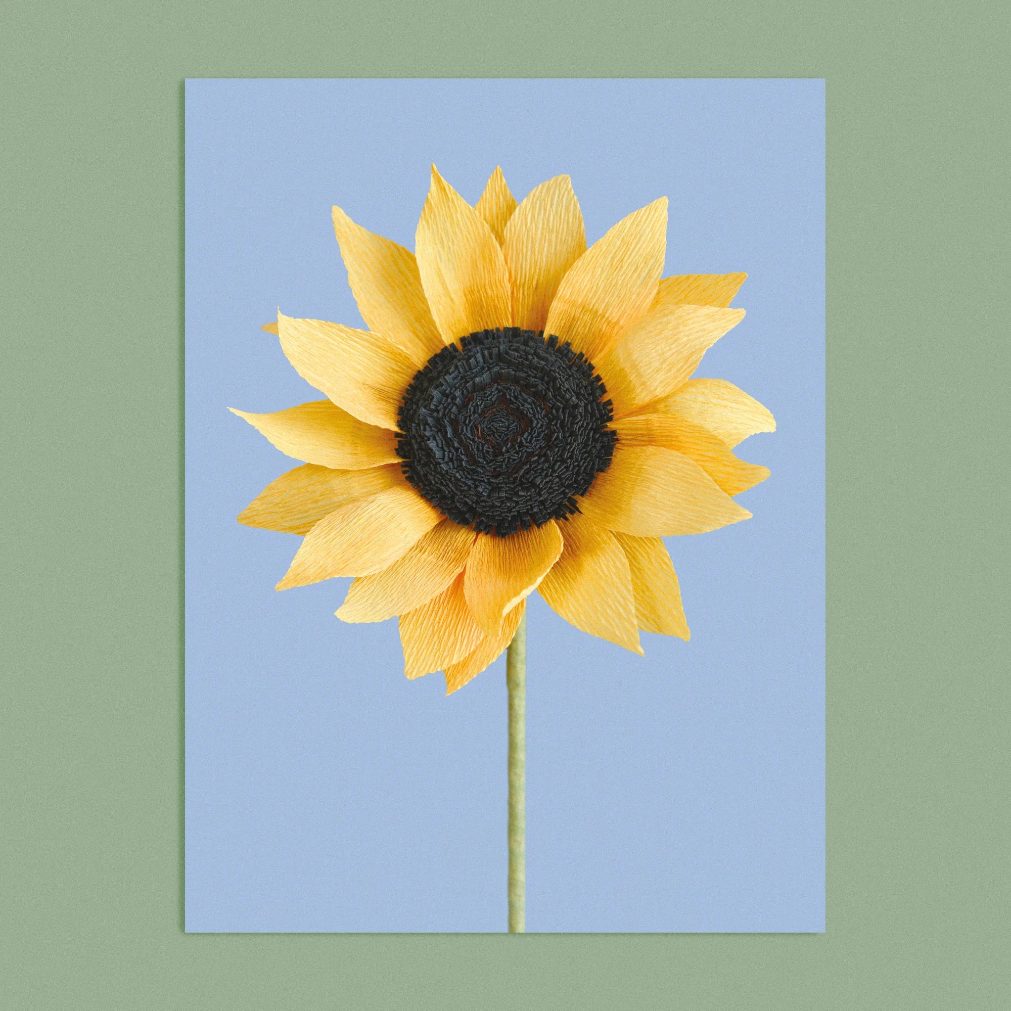 Art print with a image of a handcrafted paper sunflower on a blue background colour by paper artist Daphne Fitch.