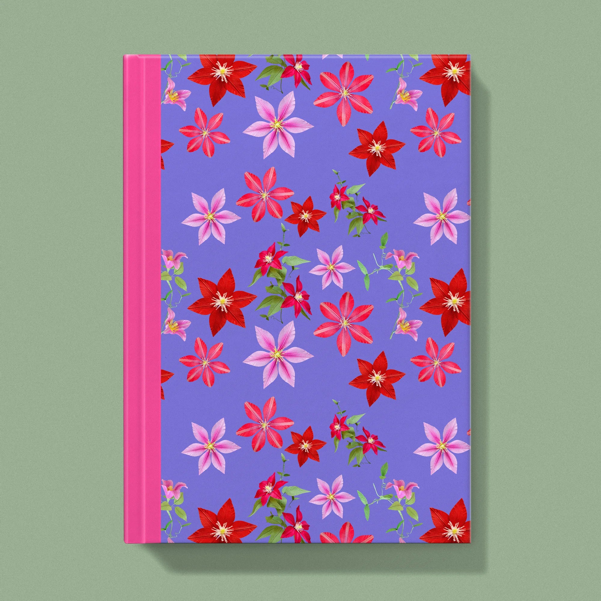 Notebook with a image of colourful handcrafted paper clematis on a purple background colour by paper artist Daphne Fitch.