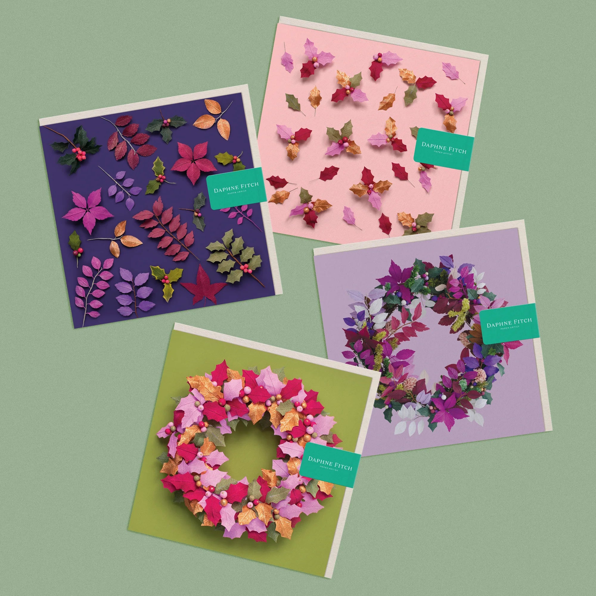 Set of 4 greeting cards, with images of a handcrafted paper festive foliage, holly and festive wreaths by paper artist Daphne Fitch.